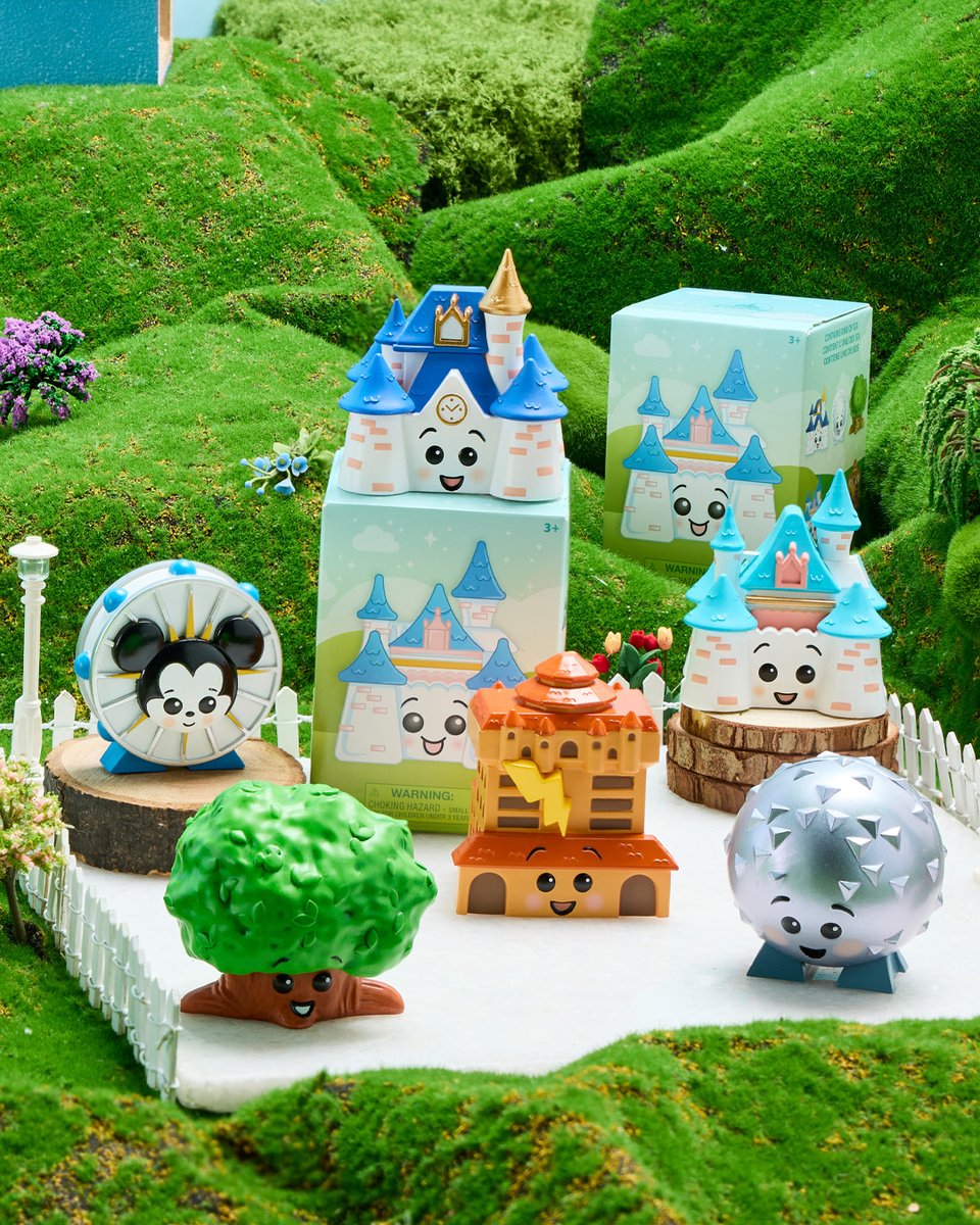 The Disney Parks Cutie Mystery Figure series, six smiling vinyl figures based on park landmarks, lined up beside pastel mystery boxes