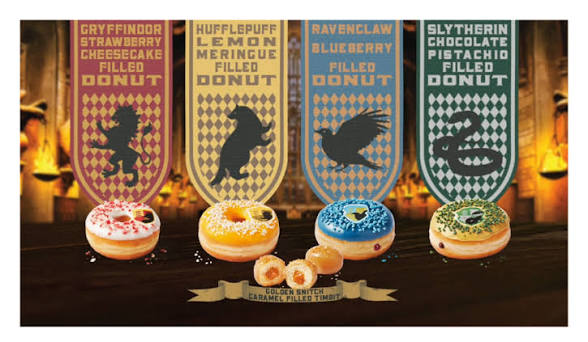 Four Hogwarts house donuts — Gryffindor, Hufflepuff, Ravenclaw, Slytherin — with Golden Snitch Caramel Timbits in the Great Hall